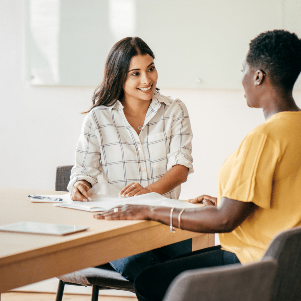 Two women sitting at a table during a job interview